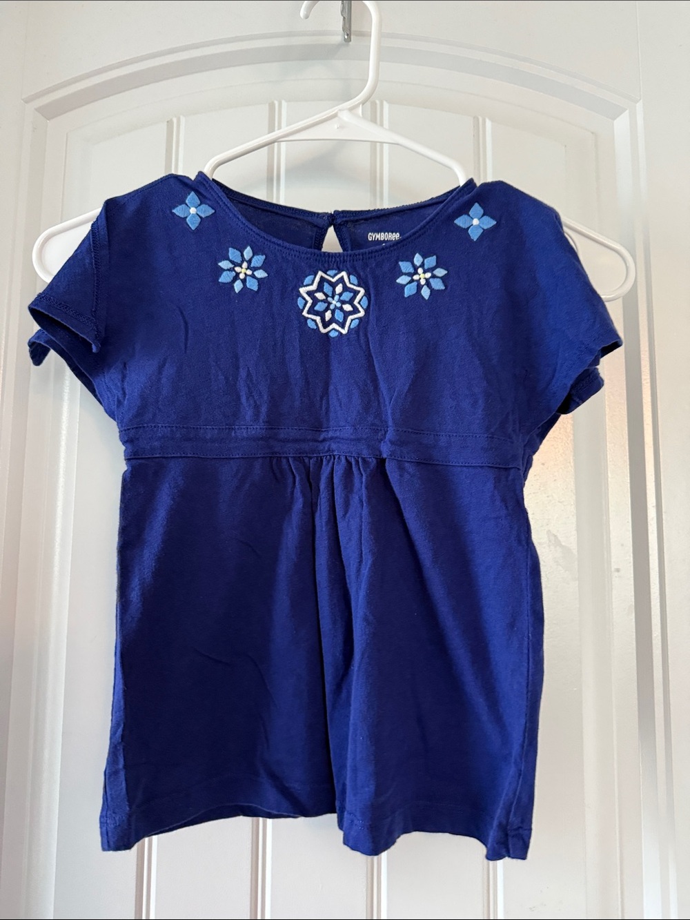 Gently worn Royal Blue Short Sleeve Top with Light Blue Floral Embroidery